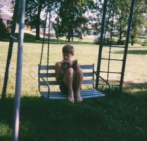 Shawn reading on swing